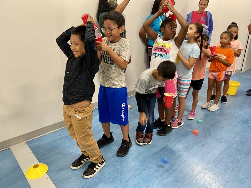 Giggling throughout the relay game are (l-r) Lester Morales Morales, Kevy Cax Trejo, Ka’Morrah Small Floyd and Lidia Mireles Pichardo.